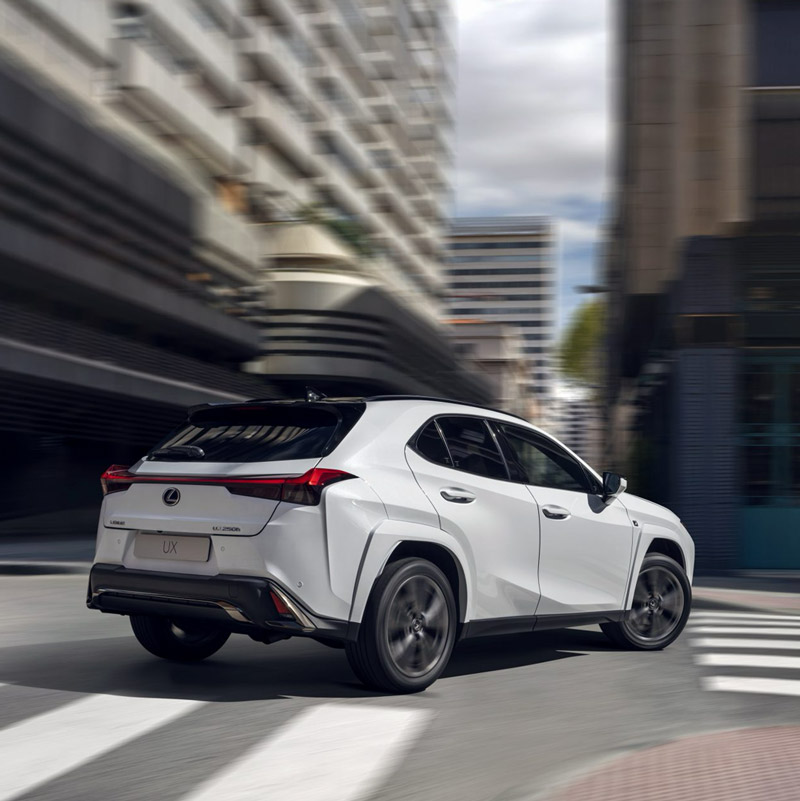 White Lexus UX navigating through the city.