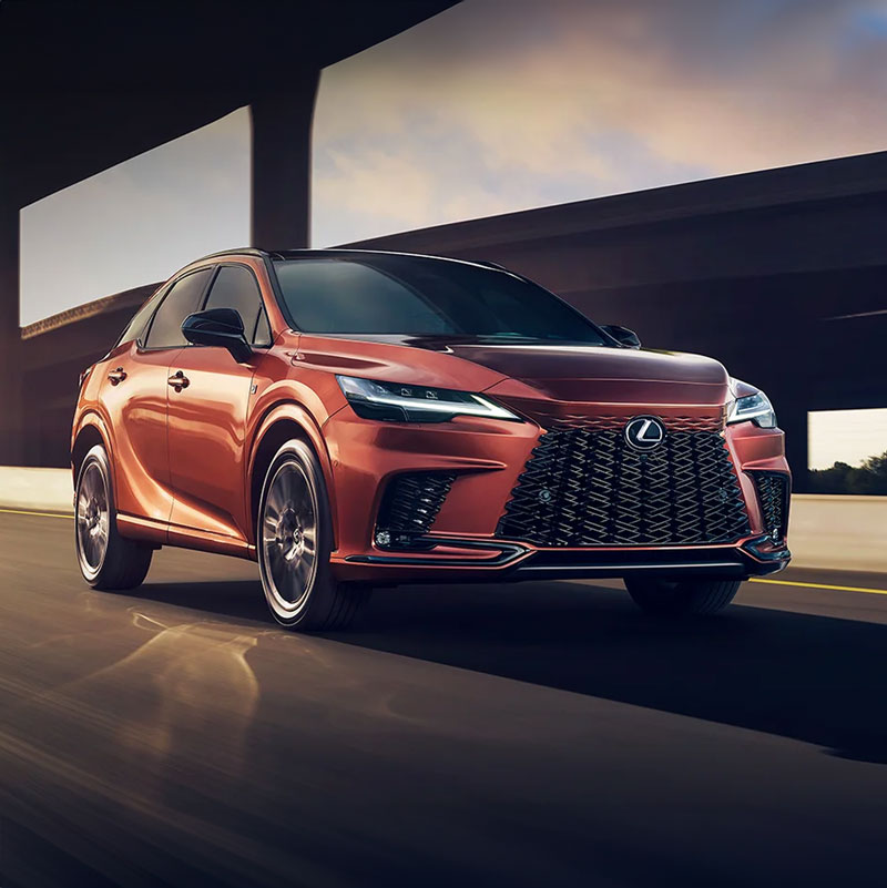Orange Lexus RX driving down a highway