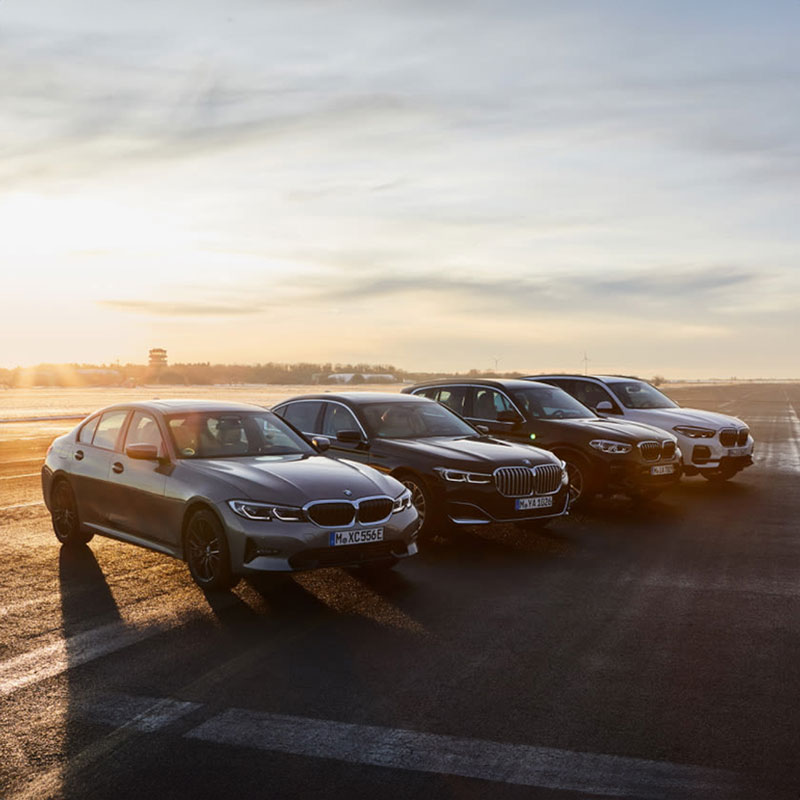A vehicle line-up of 4 BMW models in differing body styles from a sedan to SUV.