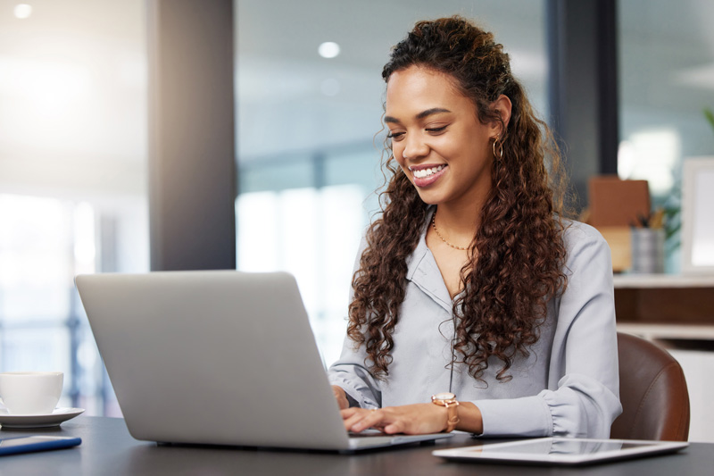 A customer using their laptop smiling.