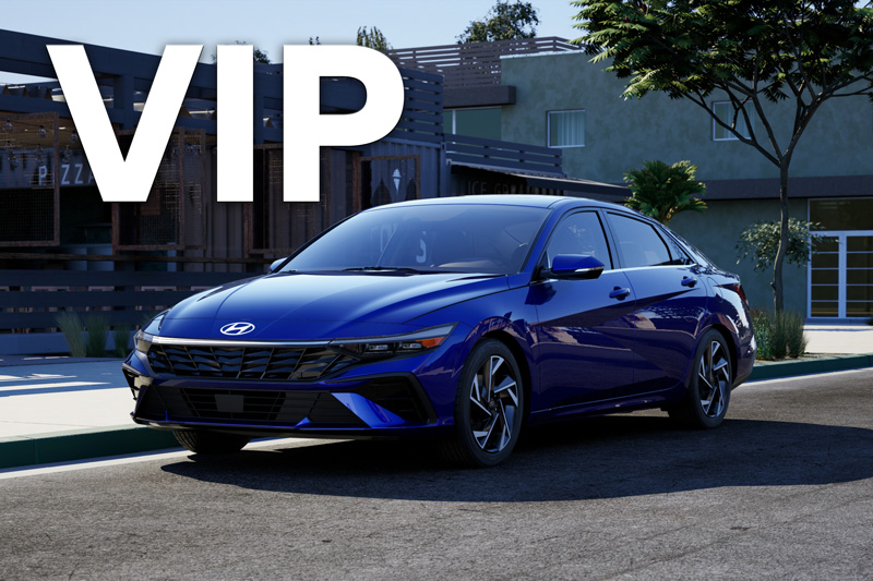 A silver Ram 1500 parked on the side of a road by a desert.