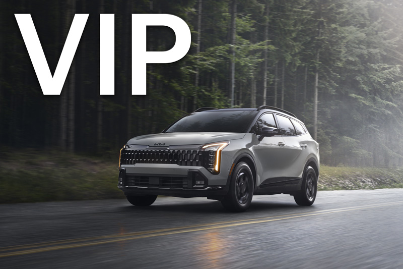 A silver Ram 1500 parked on the side of a road by a desert.