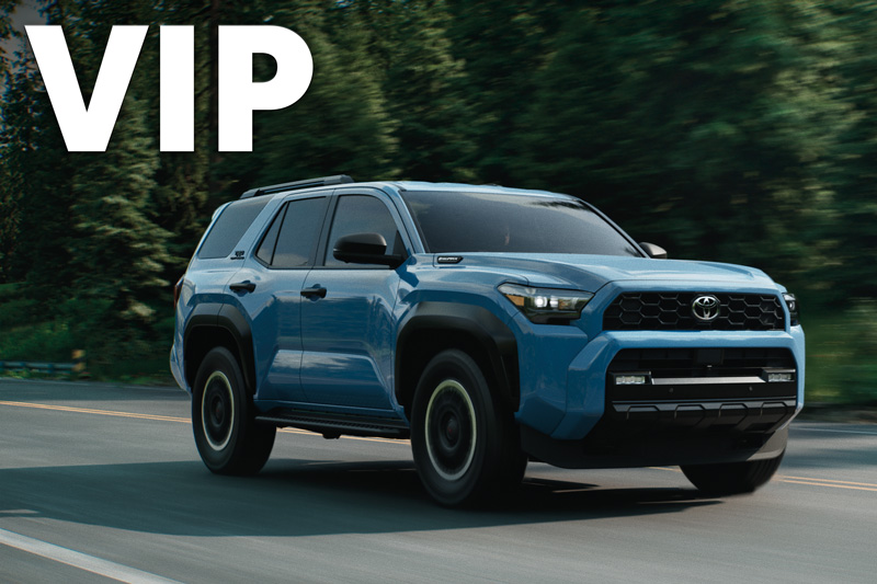 A blue Toyota RAV4 driving down a highway