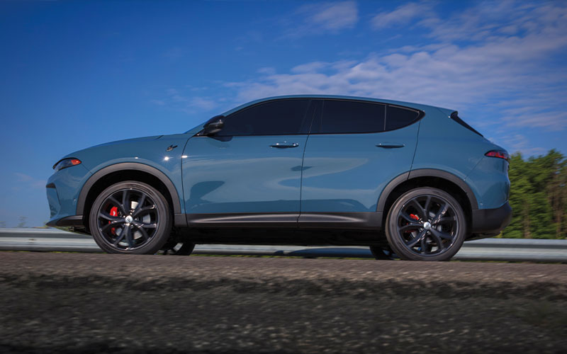 A Dodge Hornet parked on the shoulder of a road