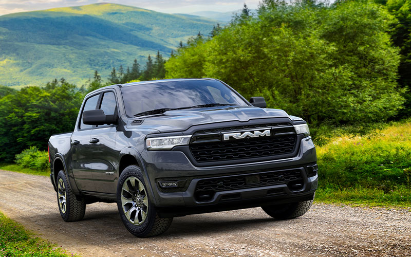 A 2025 Ram 1500 driving on a dirt road