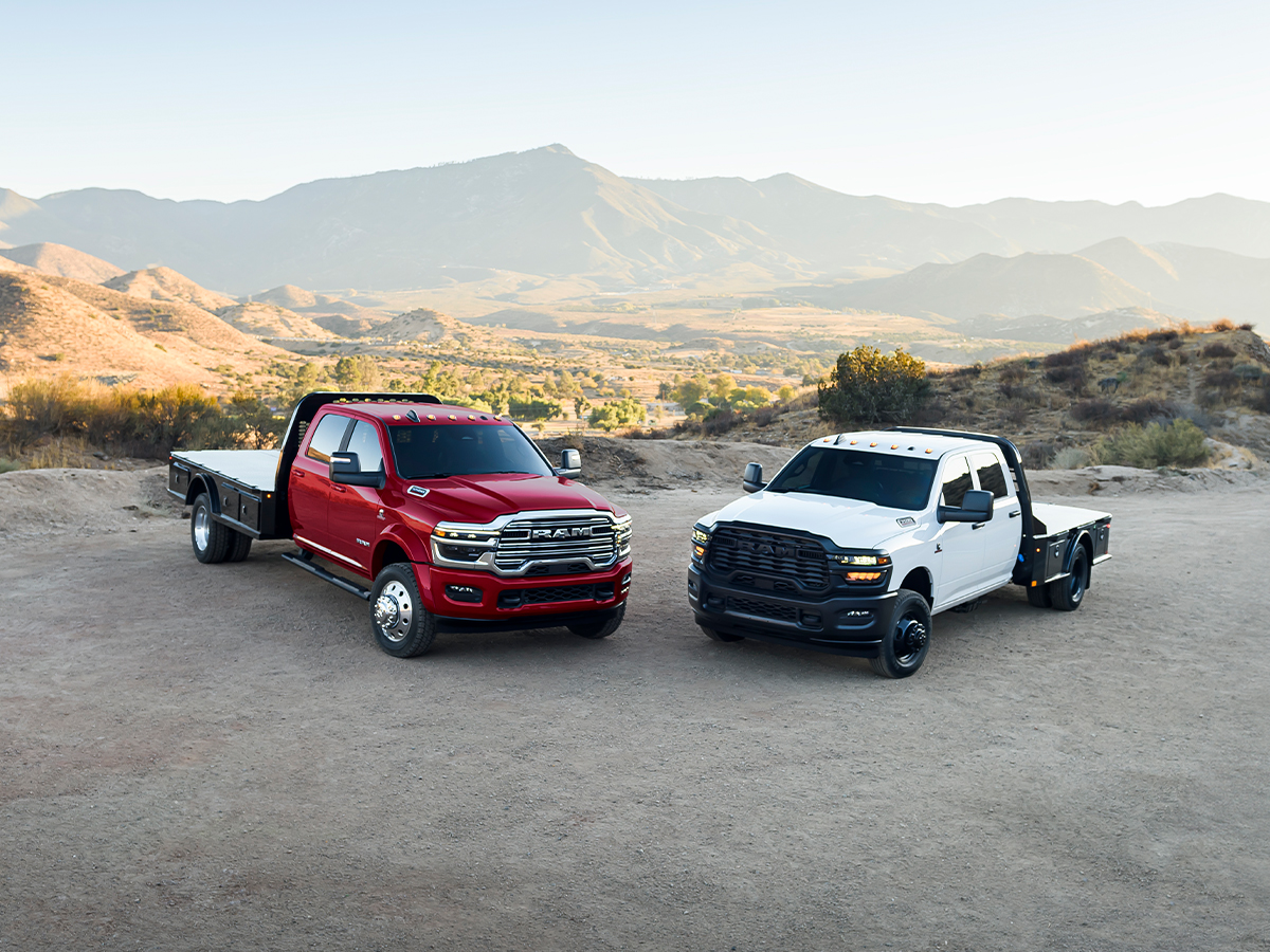Two Ram Chassis Cab trucks parked beside each other on top of a mountain.