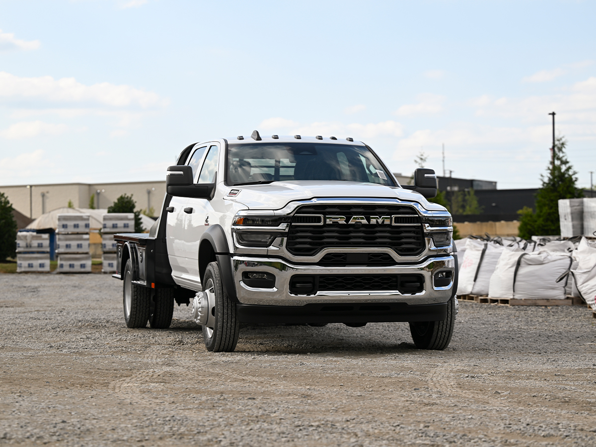 A white RAM 3500 Chassis Cab pickup truck parked at a work site.