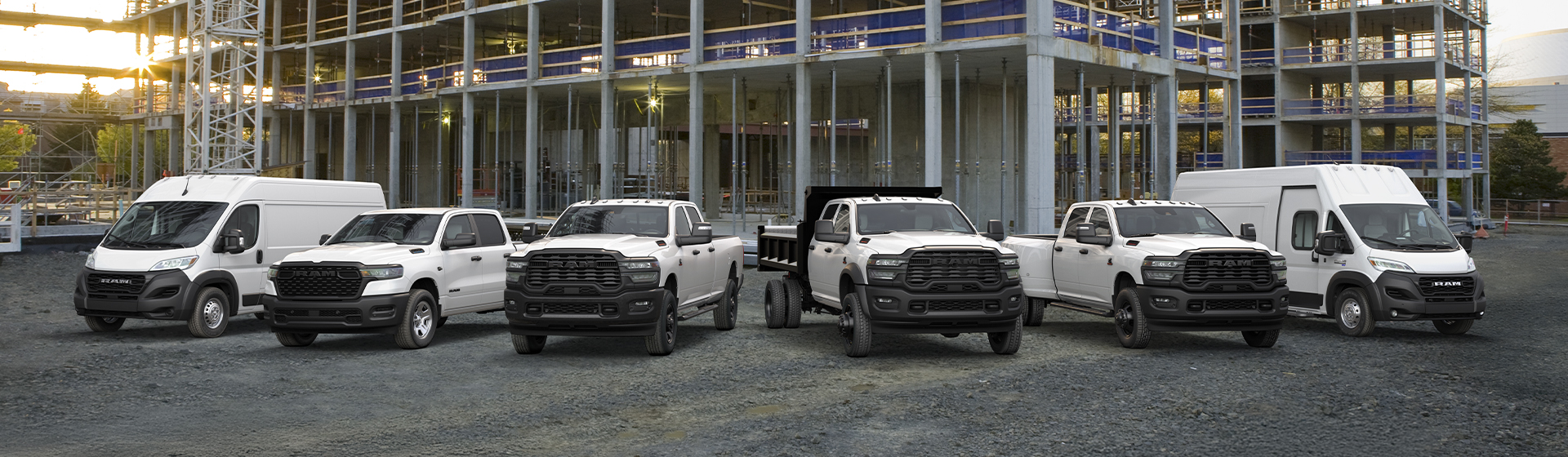 A lineup of various Ram commercial vehicles, featuring the Ram 1500, Ram Heavy Duty trucks (2500/3500), and Ram ProMaster cargo vans.