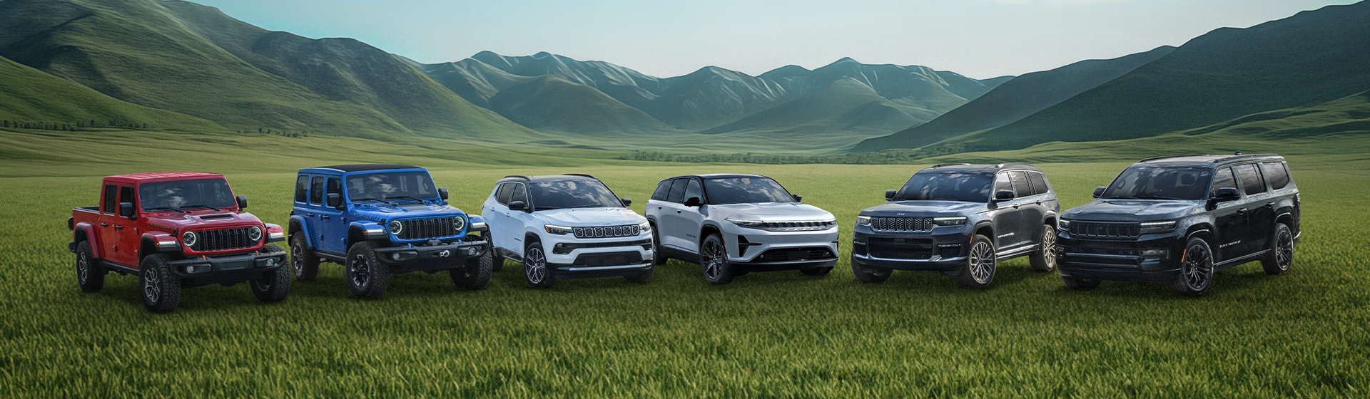 A lineup of Jeep vehicles parked in a grassy field with rolling green hills
