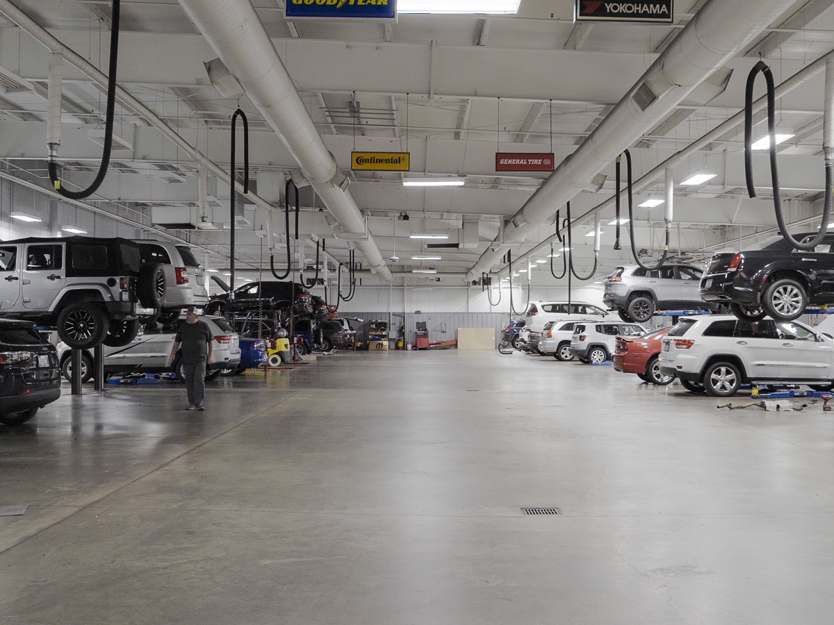 Inside the service center filled with various different vehicles of all makes and models.
