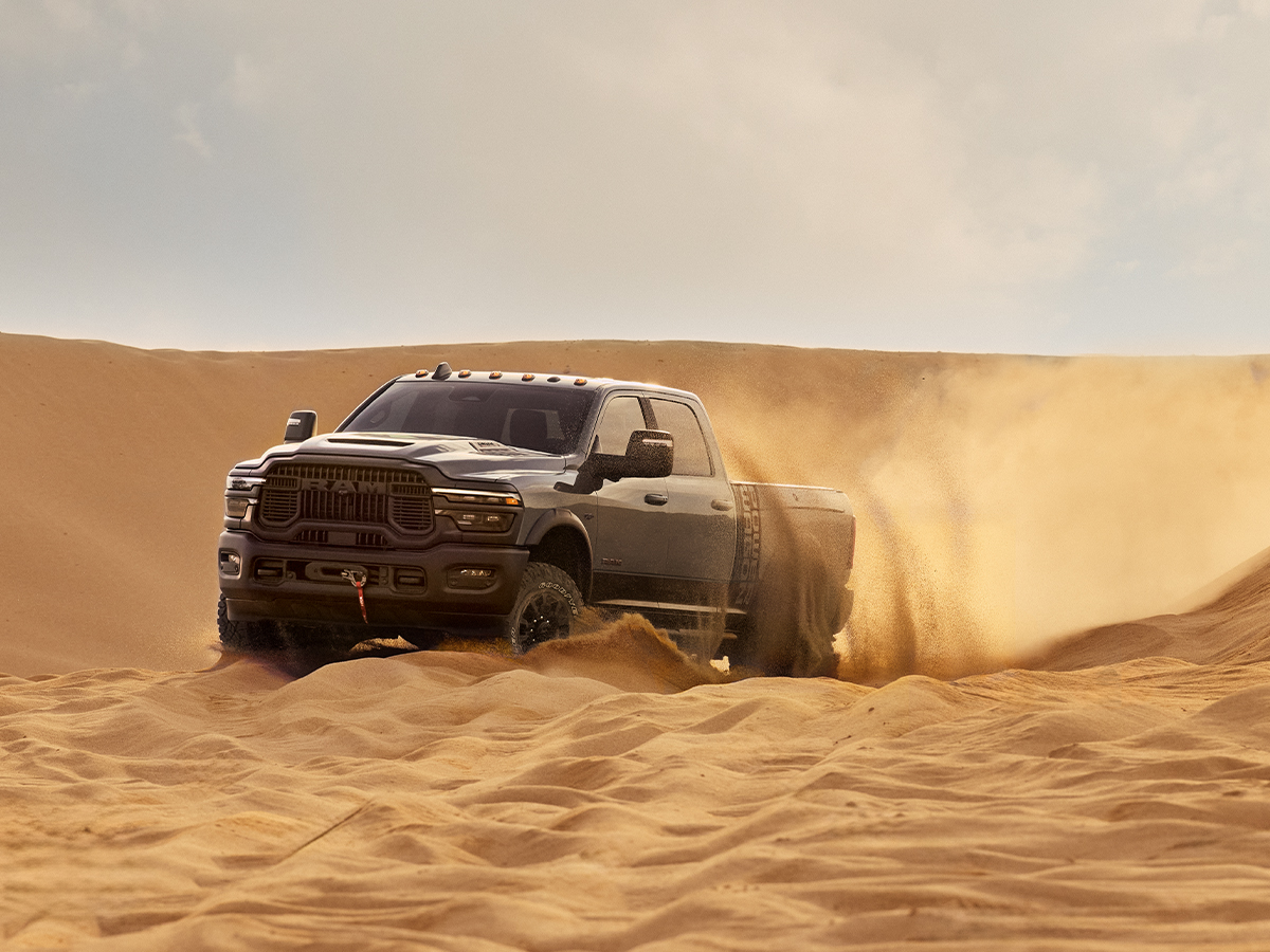 A  2026 Ram 2500 Power Wagon kicking up sand in the desert.