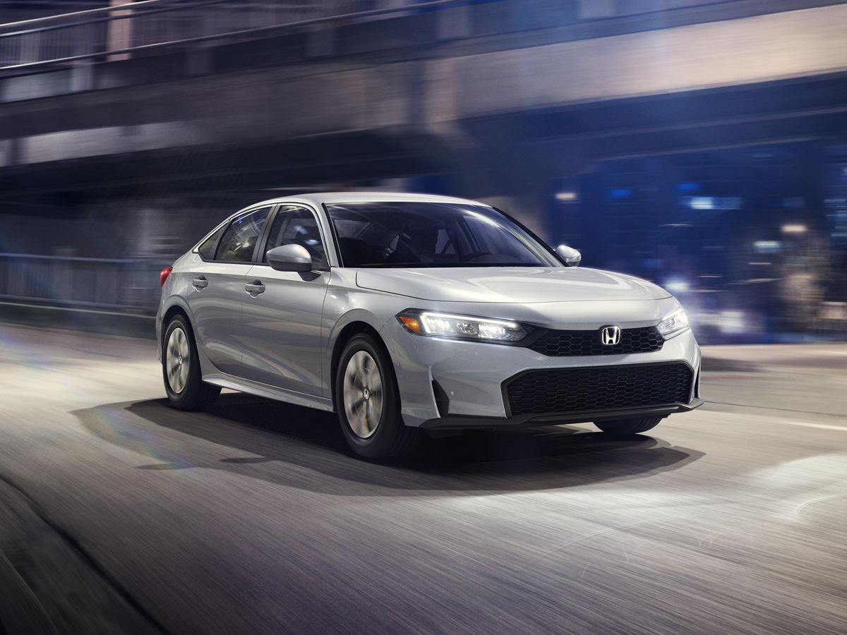 A silver 2026 Honda Civic Sedan featuring a low, wide front fascia and sharp LED headlights.