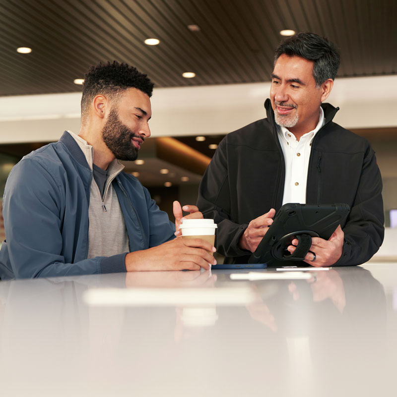 Nissan service technician talking to a customer.