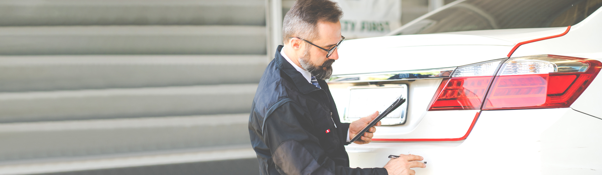 A service technician performing an inspection on a vehicle