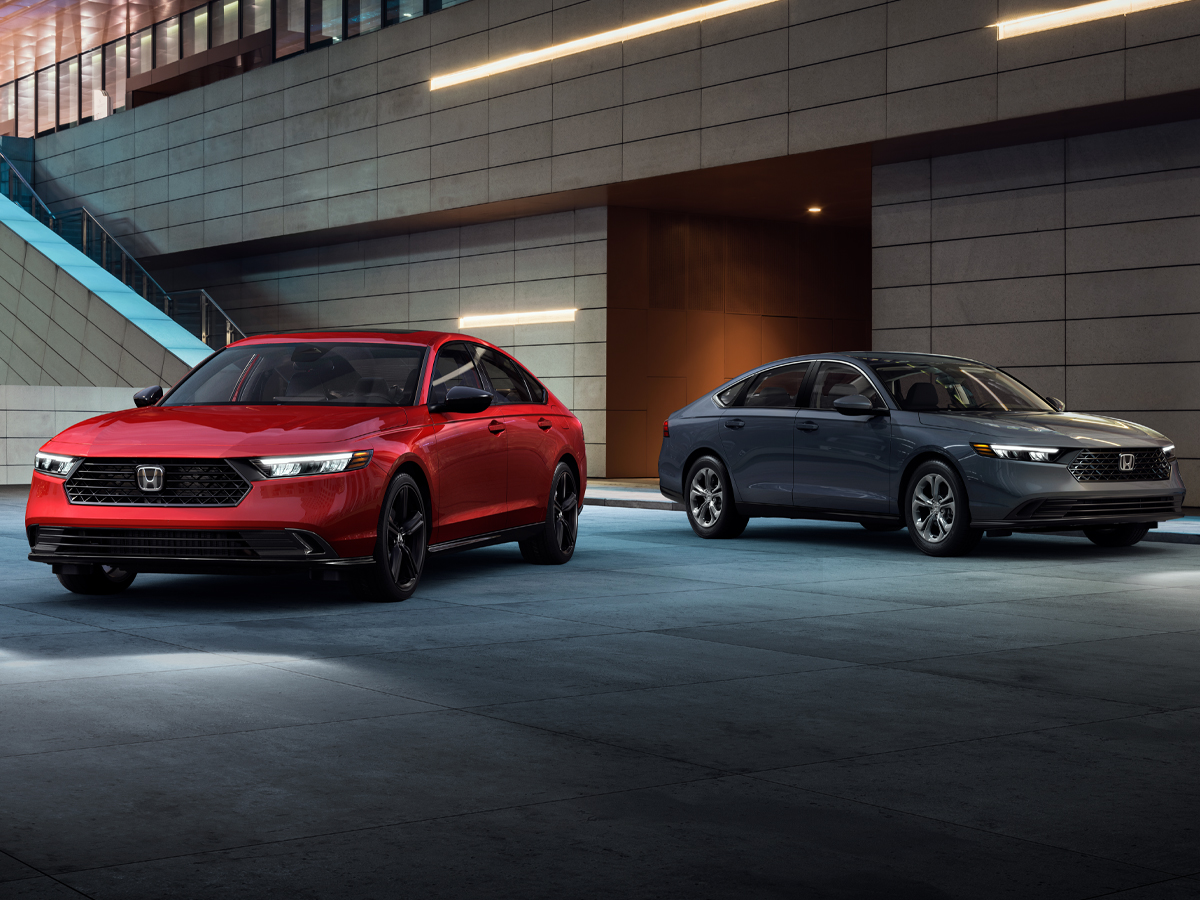 A red Honda Accord and a silver Honda Accord sedan parked beside each other.