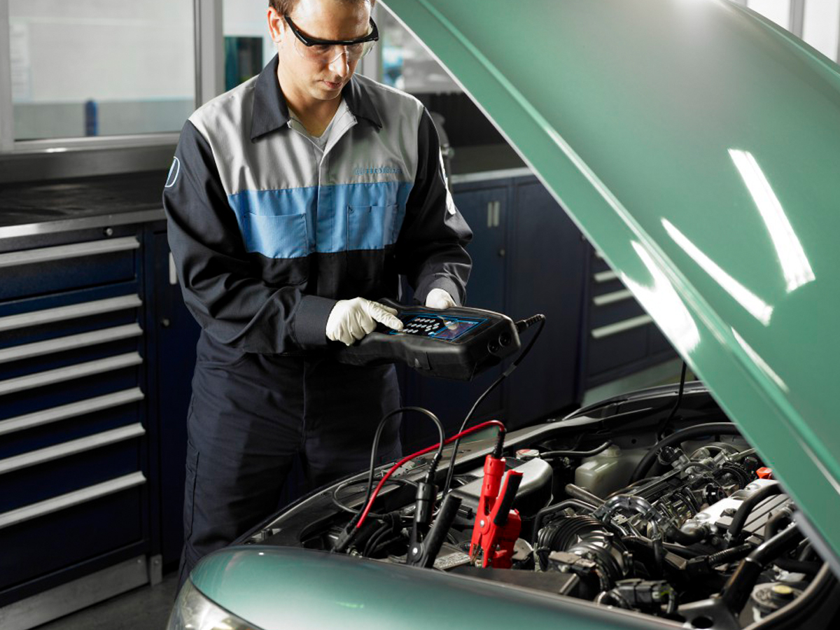 Inside the Honda of Indian Trail service center, a service technician performing a diagnosis on a vehicle.