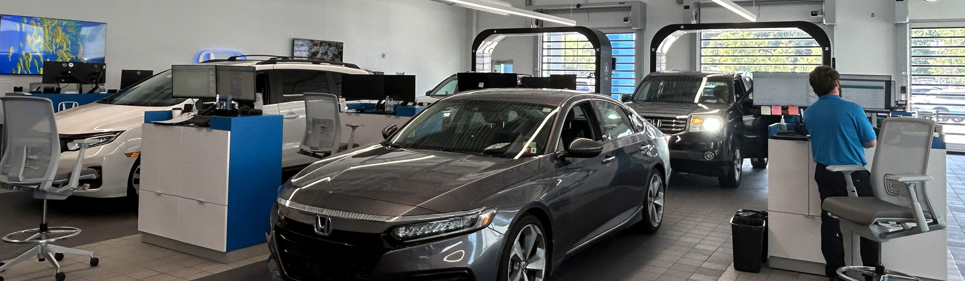 Vehicles lined up in the service center going through the UVEYE Vehicle Inspection system