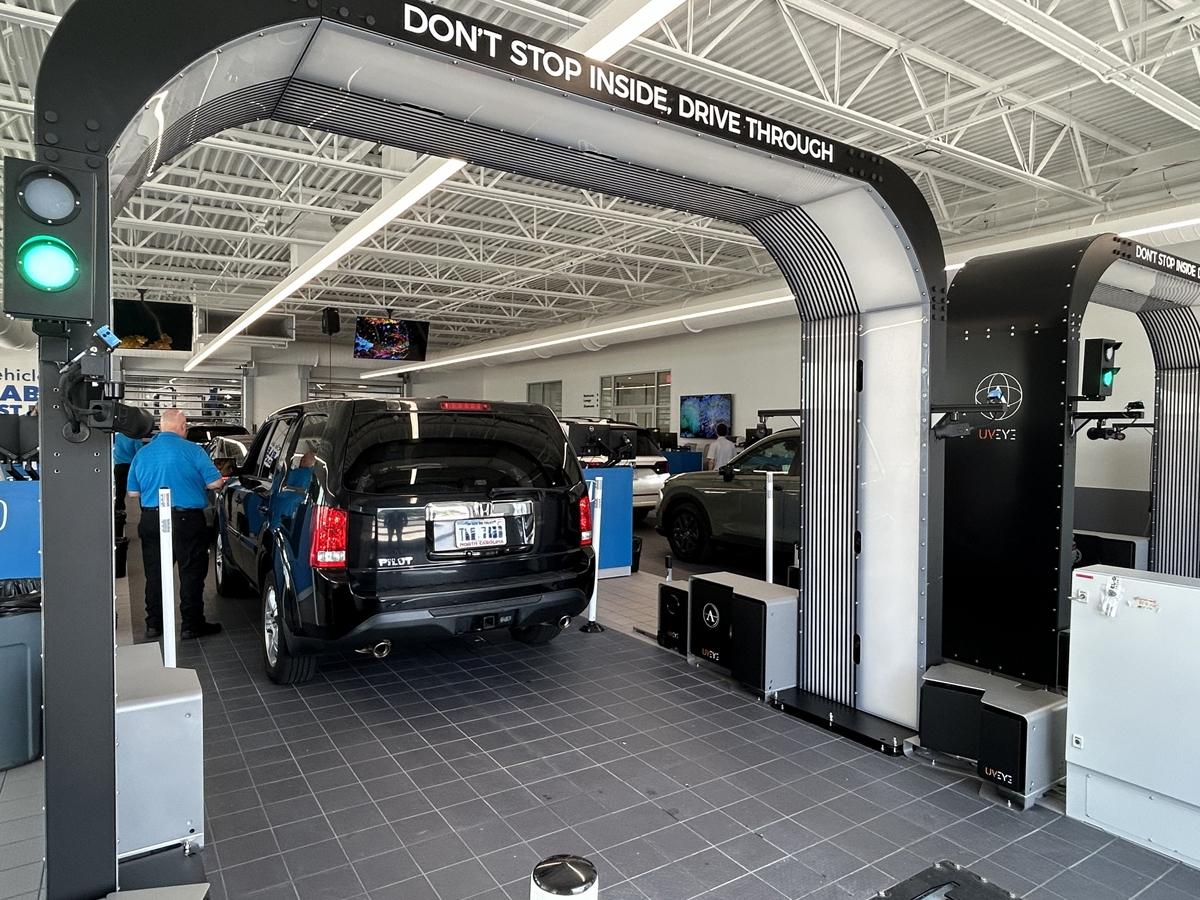 Vehicles lined up in the service center going through the UVEYE Vehicle Inspection system