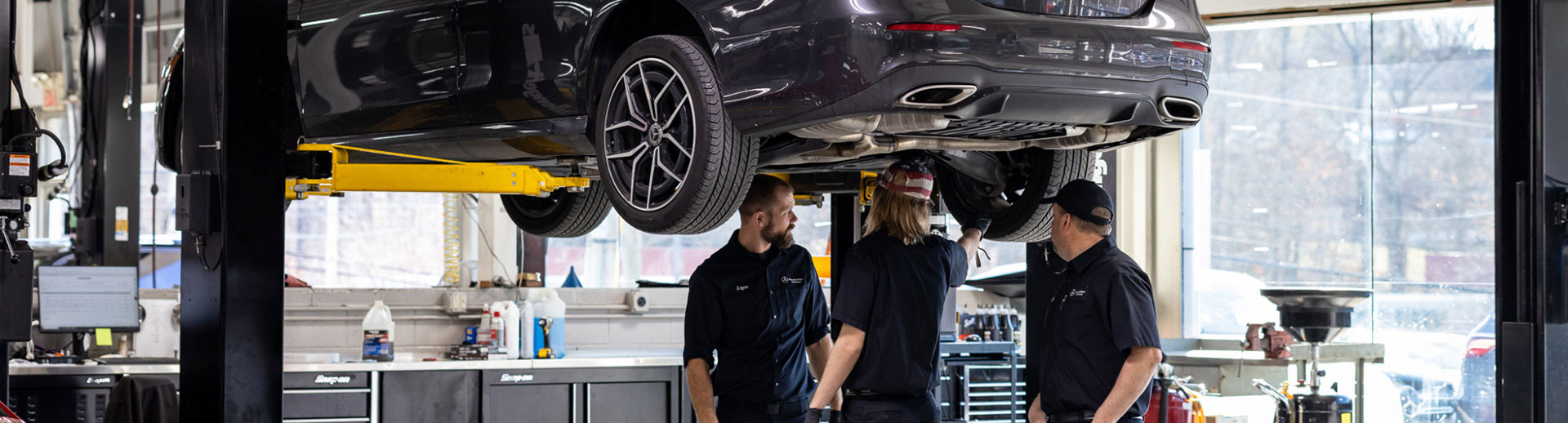 Photo of service techs inspecting the tires of a vehicle