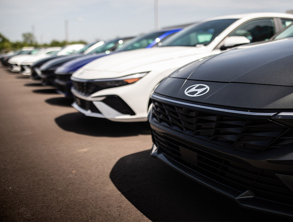 A Hyundai car salesperson showing a customer an offer