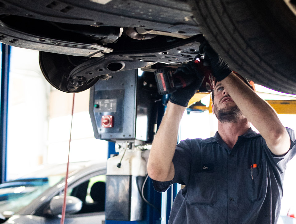 Hyundai service technicians in a Hyundai service center reviewing a vehicle diagnosis
