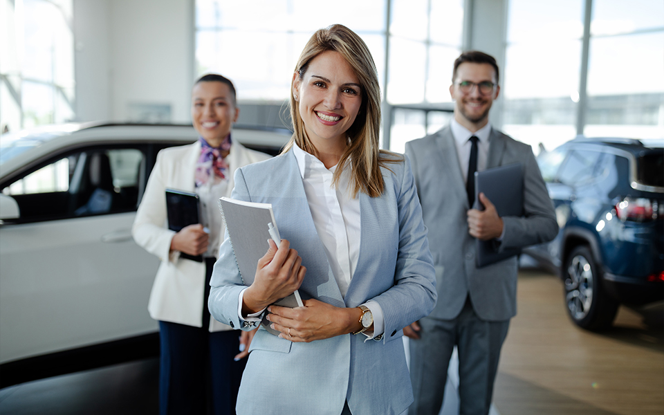 Several salespeople inside a car dealership