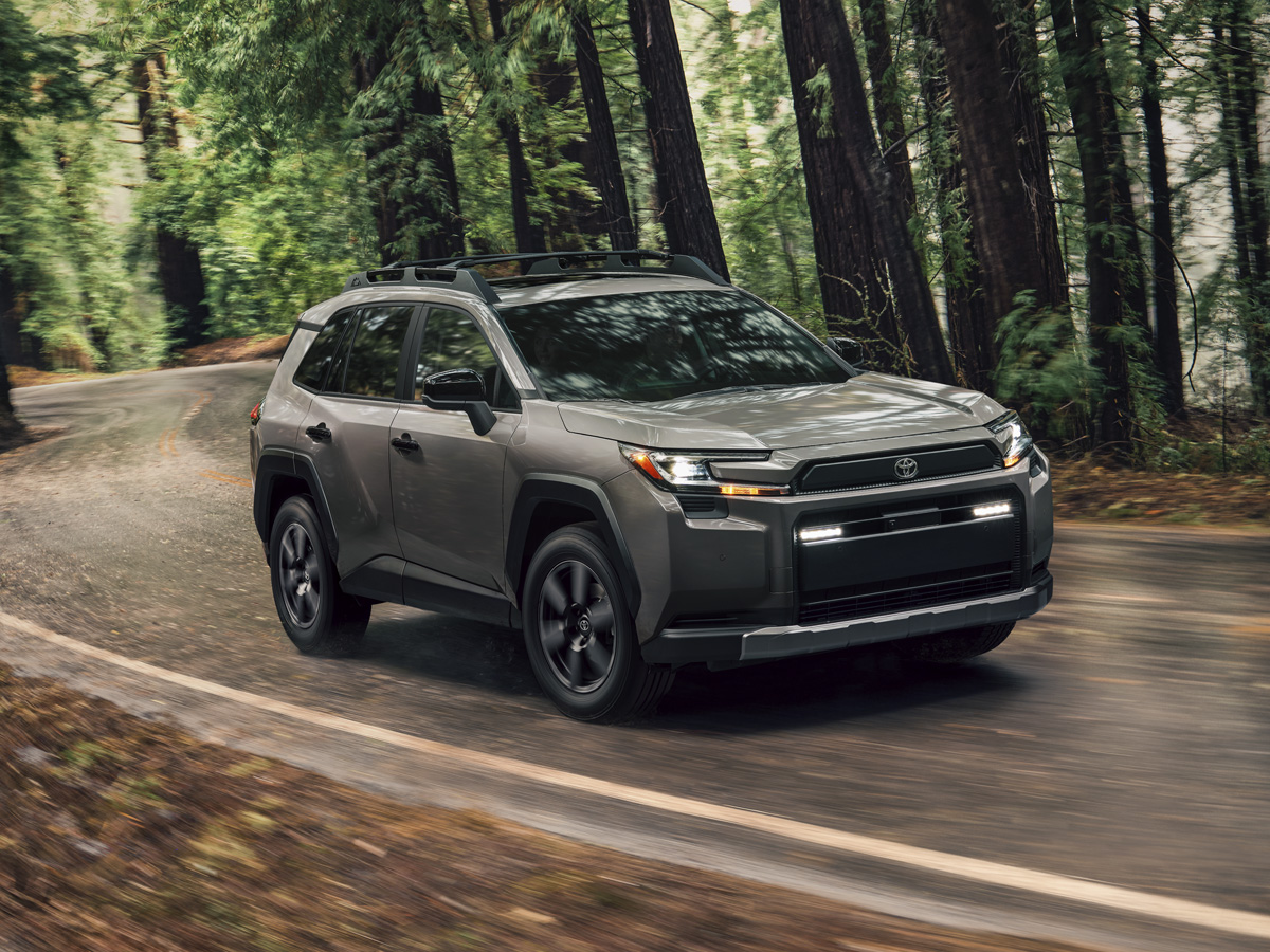 A 2026 Toyota RAV4 driving through a wooded area