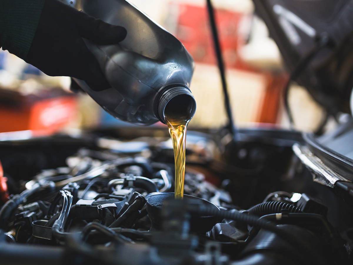 Close-up of a service technician performing an oil change