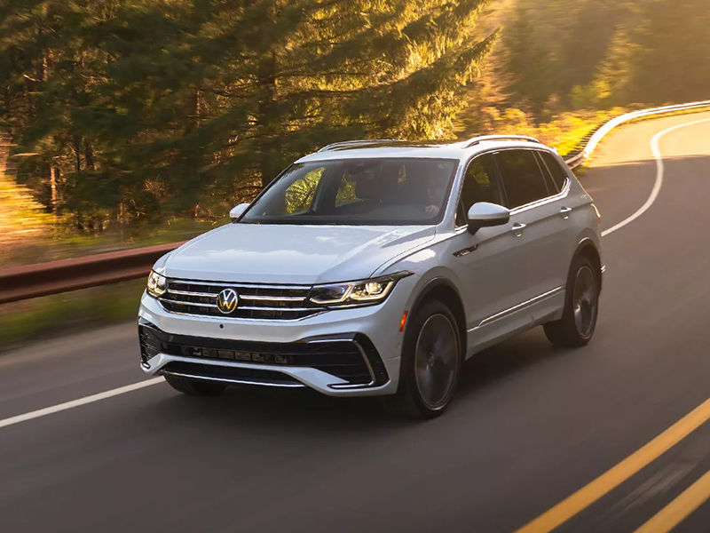 A Volkswagen Tiguan driving on the road on a sunny day