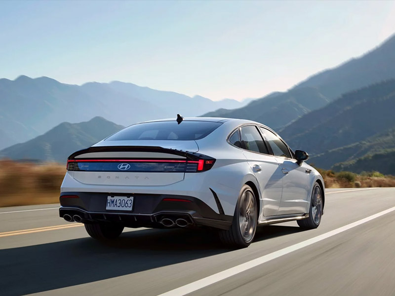 White Hyundai Sonata driving on the highway