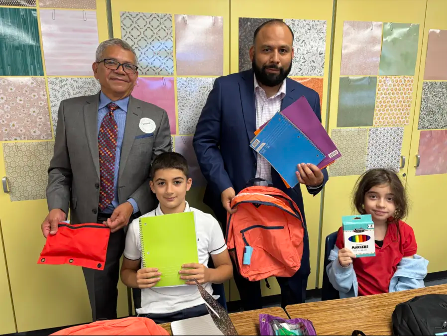 Students and teachers holding up supplies provided by Wyatt Johnson Toyota