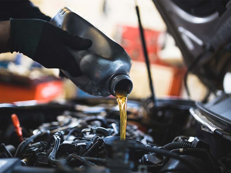 Volkswagen service technician performing an oil change