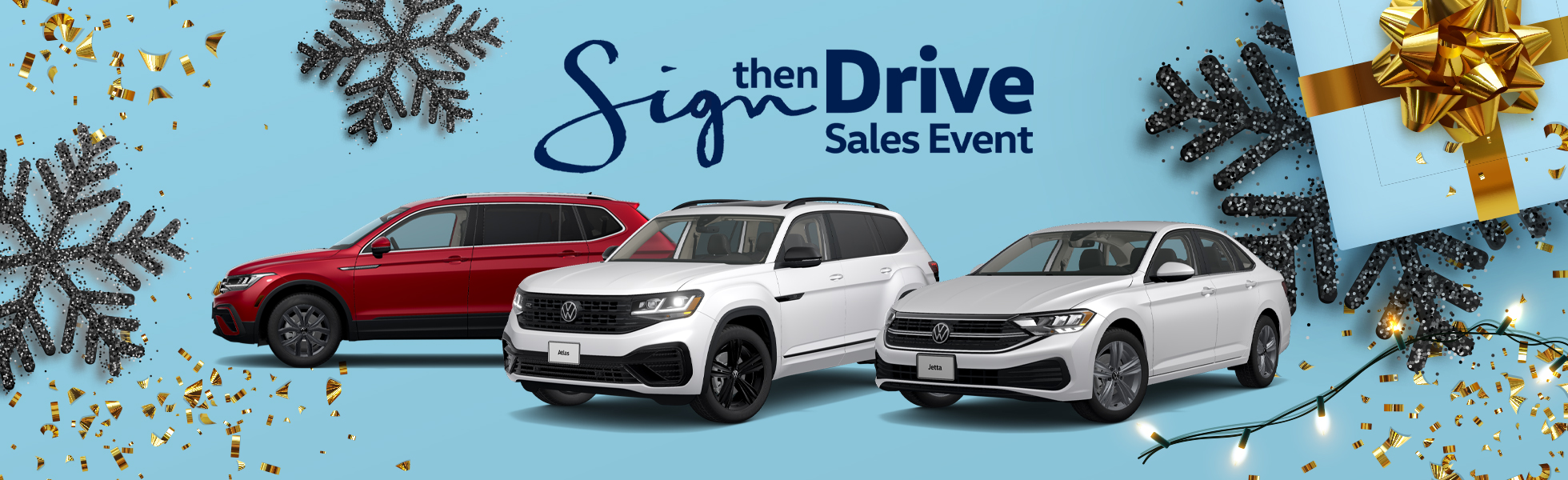 Volkswagen Sign then Drive Sales event banner featuring multiple VW models on display and winter holiday decorations
