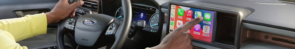Closeup photo of a driver using the Ford's CarPlay features