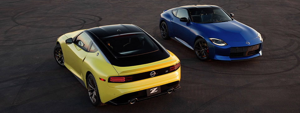 2 2023 Nissan Z vehicles in yellow and blue paint exterior photo